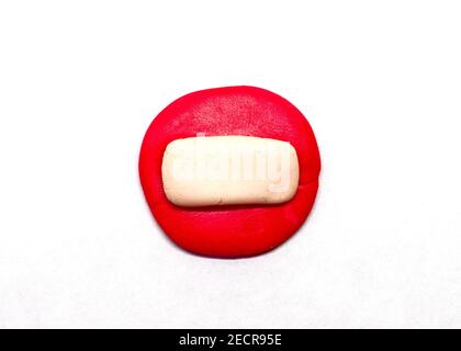Red brick or stop sign isolated. Modelling clay navigation sign on white background. Road symbol in kids art style. Children hobby modeling. Navigatio Stock Photo