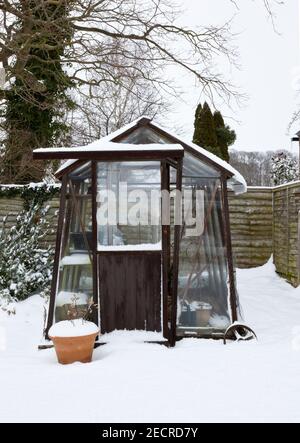 A snow covered greenhouse Stock Photo