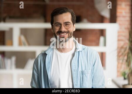 Portrait of smiling Caucasian man pose in office Stock Photo