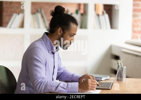 Pensive African American man work on laptop Stock Photo