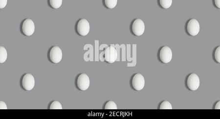 Seamless pattern with white chicken eggs on a gray background. Color of the year 2021 Ultimate Grey. Easter concept. Eggs pattern. Stock Photo