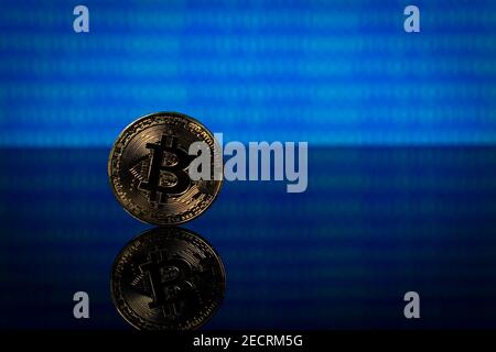 Golden bitcoin, binary code on a blue background Stock Photo