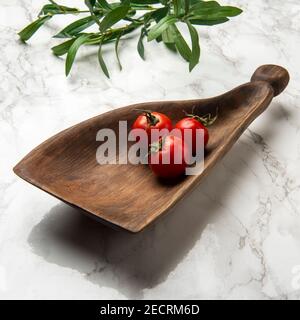 hand carved wooden snack board on the table Stock Photo