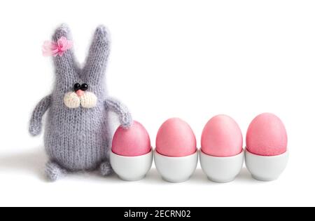 Easter bunny and painted pink eggs are isolated on a white background. Happy Easter concept. Space for text. Easter card. Stock Photo