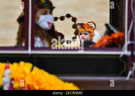 Valletta, Malta. 13th Feb, 2021. A child dressed as a tiger is seen on the street in Valletta, Malta, on Feb. 13, 2021. Maltese carnival enthusiasts do not let the COVID-19 pandemic dampen their passion for carnival as they still work on their colorful floats and exhibit them in a static art installation rather than a parade, in line with pandemic restrictions. Credit: Jonathan Borg/Xinhua/Alamy Live News Stock Photo