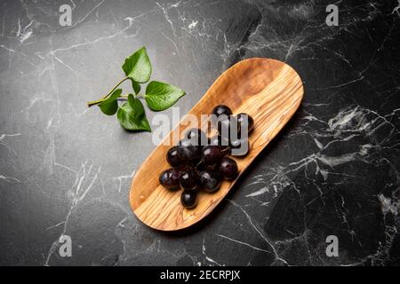 hand carved wooden snack board on the table Stock Photo