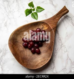 hand carved wooden snack board on the table Stock Photo