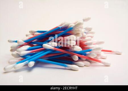 Colorful cotton swabs stacked together in an artistic arrangement on a plain background Stock Photo