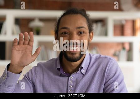 Headshot portrait of smiling ethnic African American man talk online Stock Photo