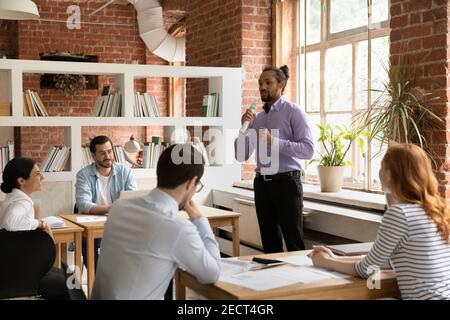 African American male leader talk in microphone in office Stock Photo