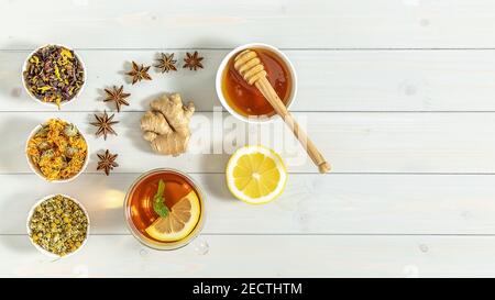 Cup of freshly brewed fruit and herbal tea with mint, lemon, and ginger. Healthy concept. Trend hard shadows Stock Photo