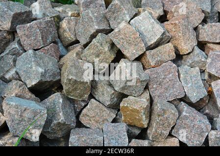 Paving stones, square stones for decorating from natural granite, very bright and beautiful. Stock Photo