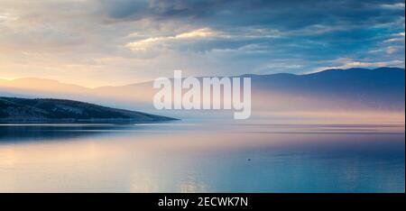 Sunlight at dawn on the Adriatic sea. View from the bay of Baska. Island Krk. Croatia. Europe. Stock Photo