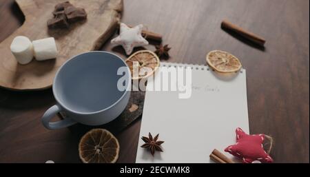 blue cup with new year goals list in notepad, wide photo Stock Photo