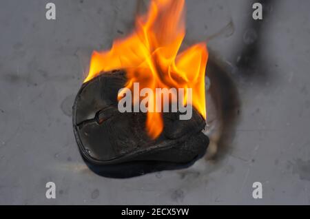 Household electrical appliance fire concept. Wireless computer mouse is ablaze. Fire safety, visual aid. Stock Photo