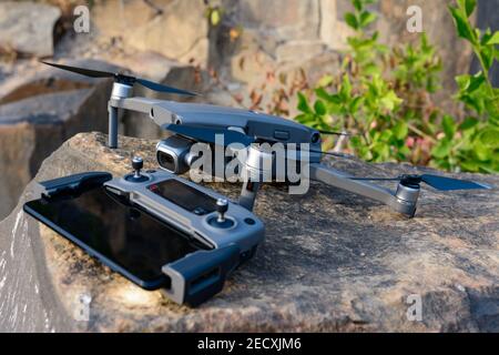 Quadcopter and remote control close up on stone, photographic equipment for flight.new Stock Photo