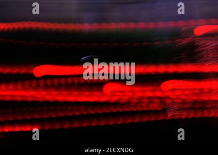 Abstract background of red neon glowing light shapes. Bright stripes Can use for poster, website, brochure, print. Stock Photo