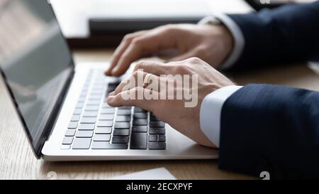 Close up of businessman typing on modern laptop Stock Photo