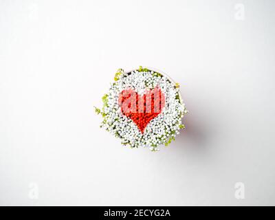 red heart made of tiny balls in a cup, top view, symbol, valentines day concept. world heart day, world health day, foster family adoption, hope, grat Stock Photo