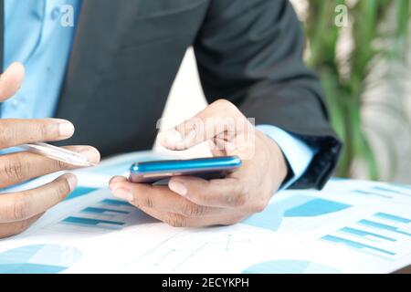businessman using smart phone while working on desk  Stock Photo