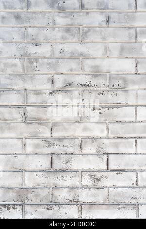 Old wall made of white brick. Rough textured surface. Construction background. Vertical frame Stock Photo