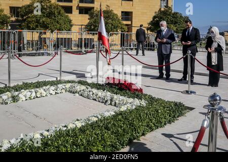 Beirut, Lebanon. 14th Feb, 2021. Lebanese designated Prime Minister Saad Hariri (C) along with his aunt Bahia (R) and uncle Shafiq recite verses of the Holy Quran and lay wreaths at the tomb of his father late Prime Minister Rafiq al-Hariri to mark the 16th anniversary of his assassination. On 14 February 2005, Rafiq al-Hariri was assassinated in a massive car bomb attack. Credit: Marwan Naamani/dpa/Alamy Live News Stock Photo