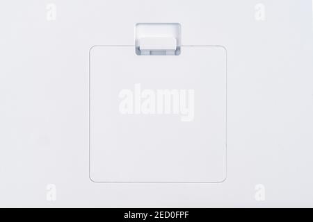 White plastic battery cover on white panel close up Stock Photo