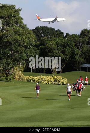 Golf - HSBC Women's Champions 2012 - Tanah Merah Country Club, Garden Course, Singapore - 24/2/12  An airplane flies overhead as golfers walk along the 2nd fairway during the second round  Mandatory Credit: Action Images / Jeremy Lee  Livepic