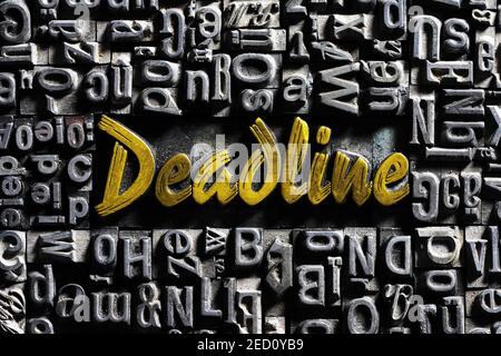 Old lead letters with golden writing, word Deadline Stock Photo