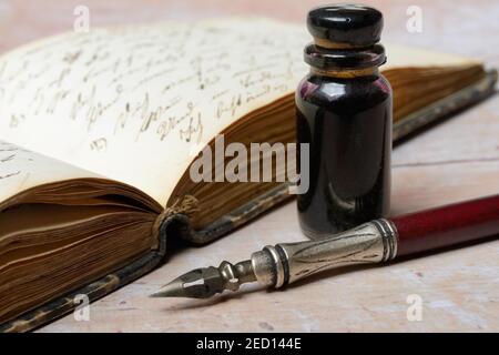 Penholder with quill, inkwell and old diary, Germany Stock Photo