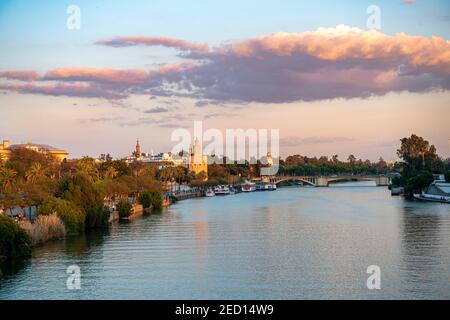 View over the river Rio Guadalquivir to Torre del Oro, sunset, Sevilla, Andalusia, Spain Stock Photo