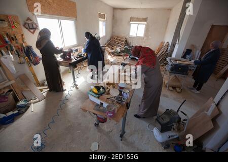 Bethlehem. 14th Feb, 2021. Palestinian women work at their carpentry shop in Al-Walajah village near the West Bank city of Bethlehem, on Feb. 14, 2021. Five years ago seven Palestinian housewives started their own project on wood recycling to make a living, turning waste timber into usable products, which were sold to souvenir shops and on social media. Credit: Luay Sababa/Xinhua/Alamy Live News Stock Photo