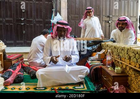 Man selling chewing sticks, old town of Jeddah, Saudi Arabia Stock Photo