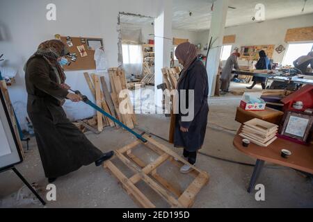 Bethlehem. 14th Feb, 2021. Palestinian women work at their carpentry shop in Al-Walajah village near the West Bank city of Bethlehem, on Feb. 14, 2021. Five years ago seven Palestinian housewives started their own project on wood recycling to make a living, turning waste timber into usable products, which were sold to souvenir shops and on social media. Credit: Luay Sababa/Xinhua/Alamy Live News Stock Photo