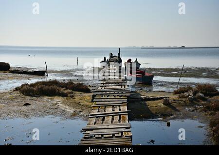 Landscape with traditional Greek fishing boats on the waters of Axios River (Axios Delta National Park) in Veroia, Central Macedonia Greece. Stock Photo