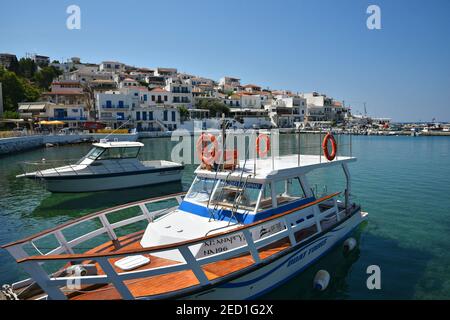 Landscape with panoramic view of Batsi port with the traditional Greek fishing boats in Andros island, Cyclades Greece. Stock Photo