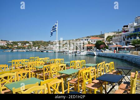 Landscape with panoramic view of colorful café furniture at the port of Batsi in Andros island, Cyclades Greece. Stock Photo