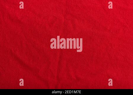 Red textured fabric with pleats. Woolen material. Stock Photo