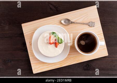 Cupcake and cup of coffee on wooden tray. top view. Stock Photo