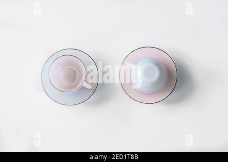 Top view of ceramic empty cups and saucers placed on white background in studio Stock Photo
