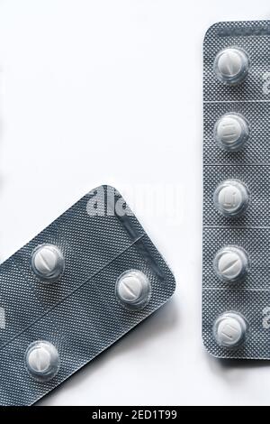 Closeup top view of full frame background of various white pills in plastic blisters Stock Photo