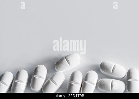 Top view of assorted white pills placed on white table Stock Photo