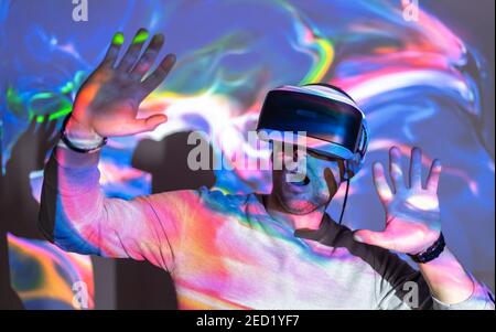 Side view of crop tattooed male sound engineer working with control panel on audio board in recording studio Stock Photo