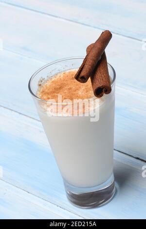 Cinnamon milk in glass and cinnamon sticks Stock Photo