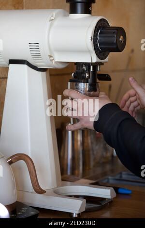 https://l450v.alamy.com/450v/2ed230d/barista-hands-grinding-coffee-with-white-mahlkonig-ek-43-grinder-in-coffee-shop-closeup-no-people-2ed230d.jpg