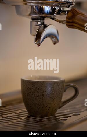 espresso coffee pouring into ceramic cup, closeup, nobody Stock Photo