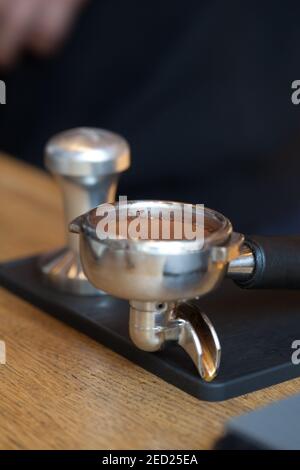 coffee grind temped in espresso holder on table, closeup, nobody Stock Photo