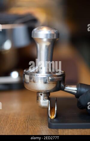 temper in espresso coffee holder on table in coffee shop, closeup, nobody Stock Photo