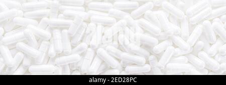 Long panoramic background with whites medical capsules. Top panoramic view Stock Photo