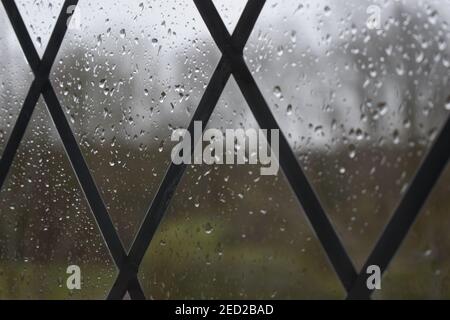 Raindrops on a leaded window pane. Stock Photo